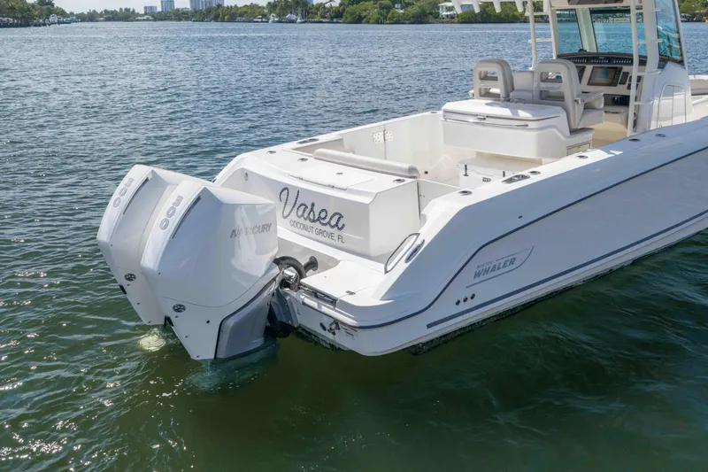 Slide: The Image of 2021 Boston Whaler 330 Outrage boat with dual Mercury engines on the water. - 11