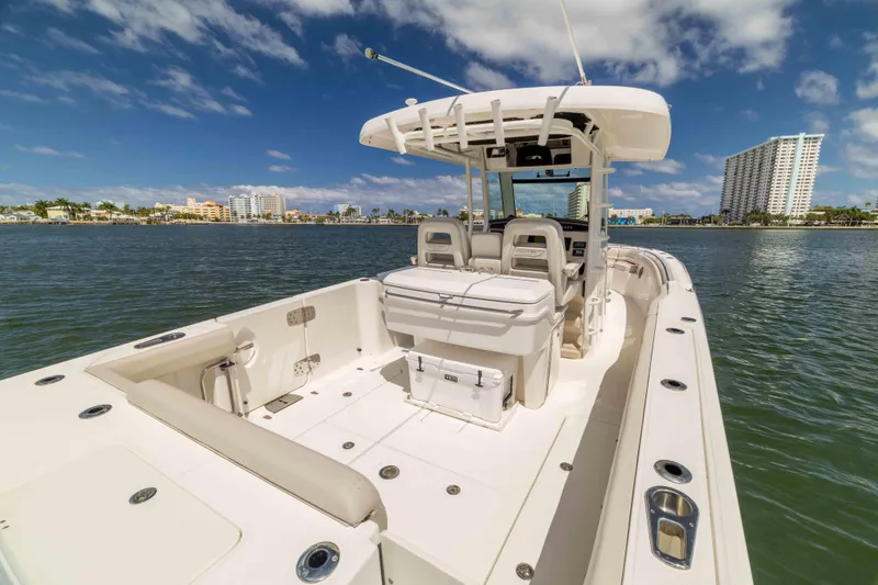 Slide: The Image of 2021 Boston Whaler 330 Outrage boat on water with city skyline background. - 19