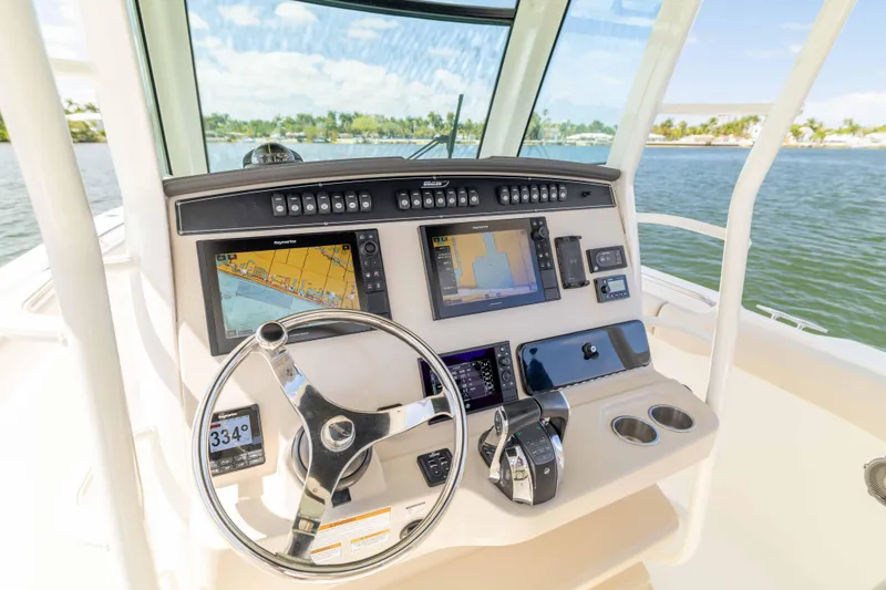 Slide: The Image of Helm of 2021 Boston Whaler 330 Outrage with advanced navigation displays and controls. - 20