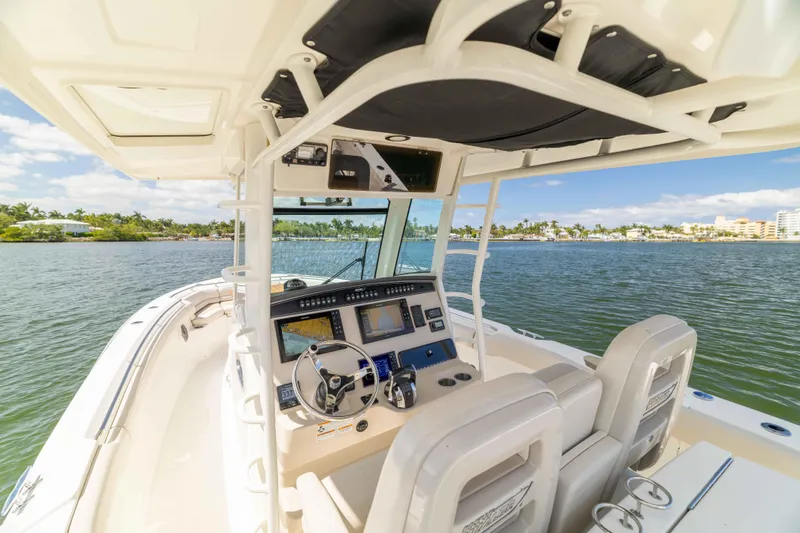 Slide: The Image of 2021 Boston Whaler 330 Outrage boat interior with advanced navigation system on a sunny day. - 24