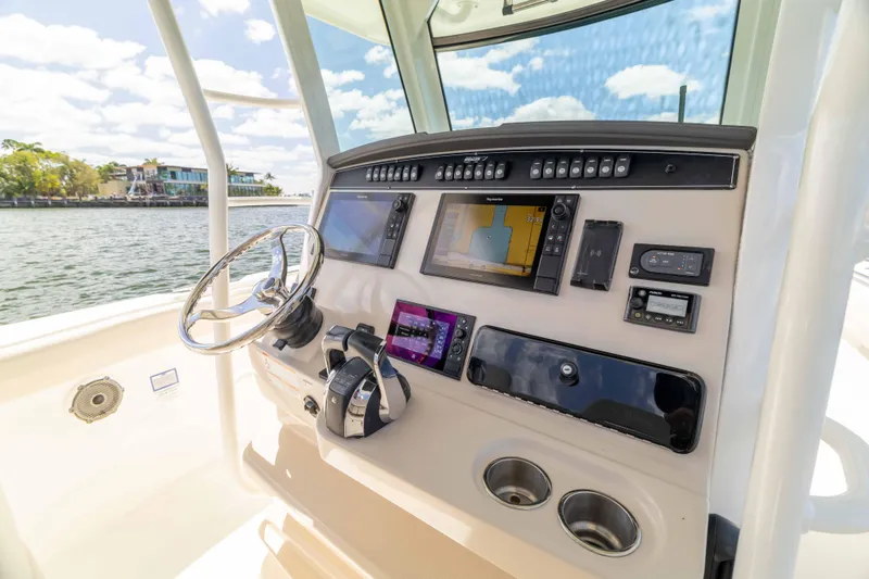 Slide: The Image of Control panel of a 2021 Boston Whaler 330 Outrage boat with navigation equipment. - 29