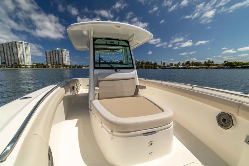 Slide: The Image of 2021 Boston Whaler 330 Outrage boat on calm water with city skyline. - 35