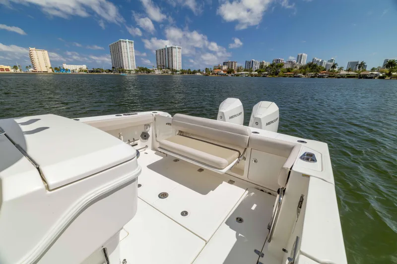 Slide: The Image of Boston Whaler 330 Outrage 2021 boat on water with city skyline in background. - 38