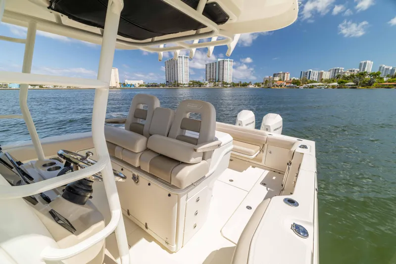 Slide: The Image of 2021 Boston Whaler 330 Outrage boat on water with city skyline in background. - 40
