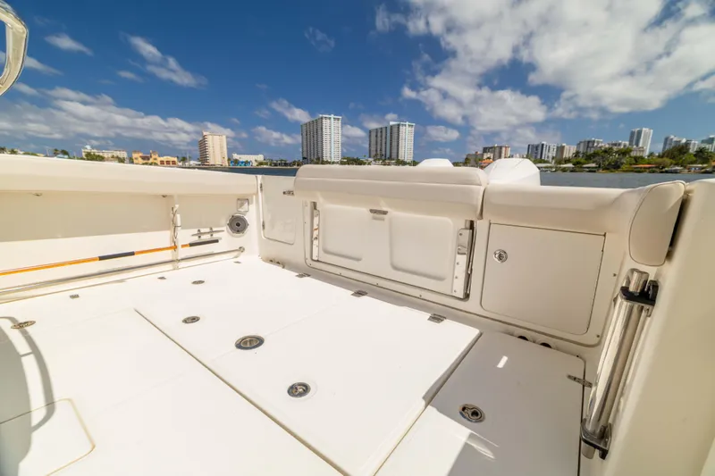 Slide: The Image of 2021 Boston Whaler 330 Outrage boat deck with city skyline in background. - 43