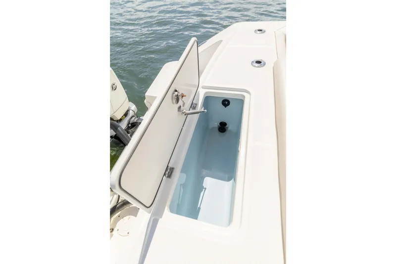 Slide: The Image of Open storage compartment on a 2021 Boston Whaler 330 Outrage boat, near water. - 46