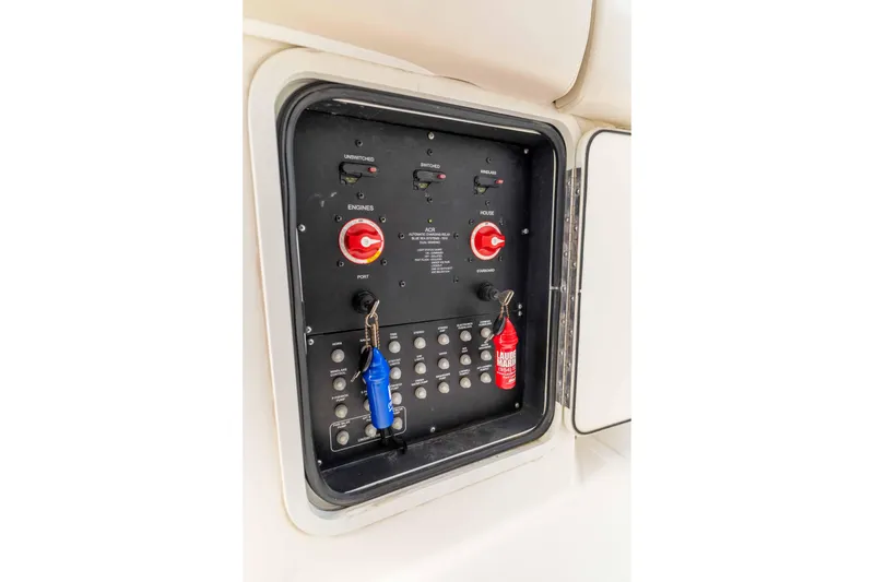 Slide: The Image of Control panel of a 2021 Boston Whaler 330 Outrage boat with switches and keys. - 50