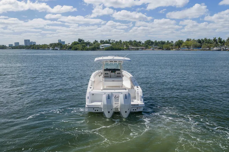 Slide: The Image of 2021 Boston Whaler 330 Outrage on calm water, scenic background. - 7