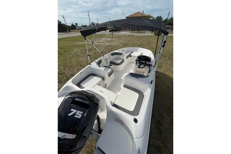 Slide: The Image of 2026 Bayliner Element E16 boat with Mercury 75 engine, featuring spacious seating and canopy. - 12