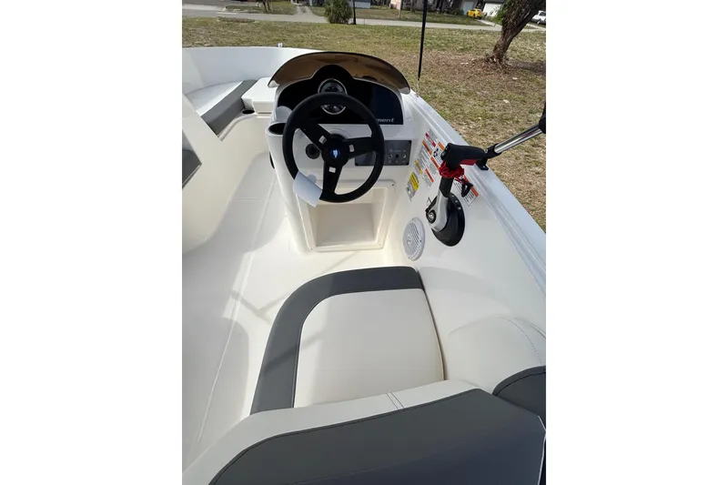 Slide: The Image of 2026 Bayliner Element E16 boat interior with steering wheel and seating. - 14