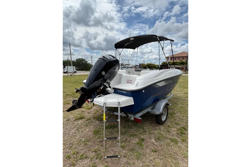 Slide: The Image of 2026 Bayliner Element E16 boat with outboard motor and canopy on trailer. - 19