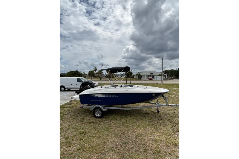 Slide: The Image of 2026 Bayliner Element E16 boat on trailer under cloudy sky. - 9