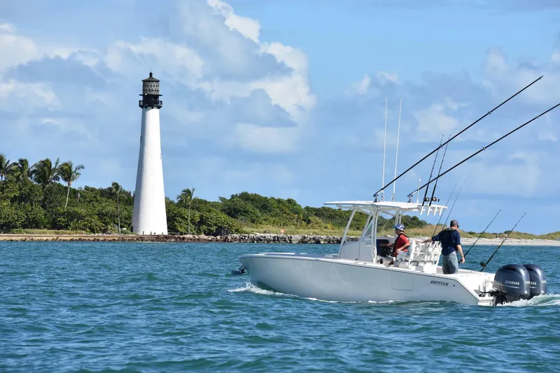 Slide: The Image of Fishing boat near lighthouse on a sunny day, Jupiter 26 model, 2026. - 3