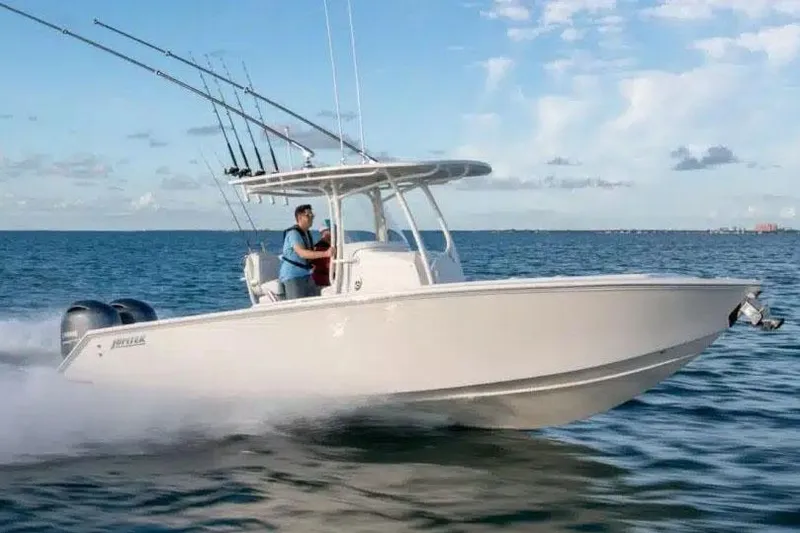 Slide: The Image of Manufacturer Provided Image: 2026 Jupiter 26 boat cruising on open water under a clear blue sky. - 4