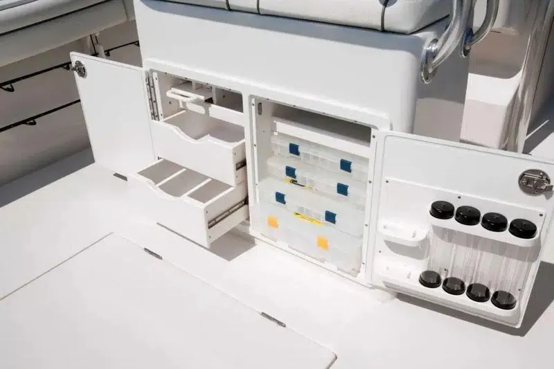Slide: The Image of Manufacturer Provided Image: Open storage compartments on a 2026 Jupiter 26 boat, featuring organized drawers and holders. - 8