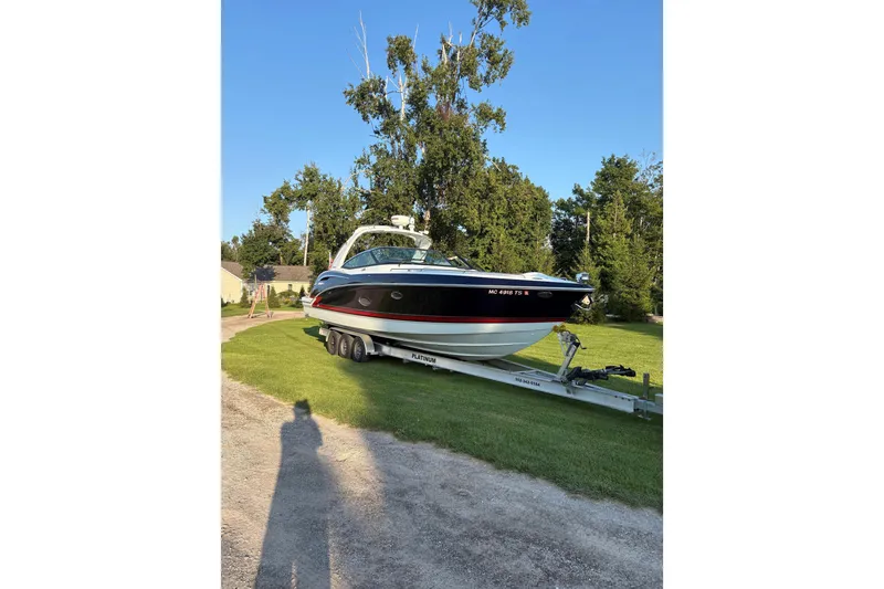 Slide: The Image of 2015 Formula 350 Crossover Bowrider on trailer, parked on grass, sunny day. - 11