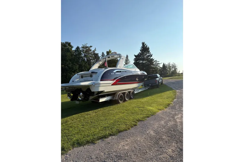 Slide: The Image of 2015 Formula 350 Crossover Bowrider on trailer, parked on grass, sunny day. - 12
