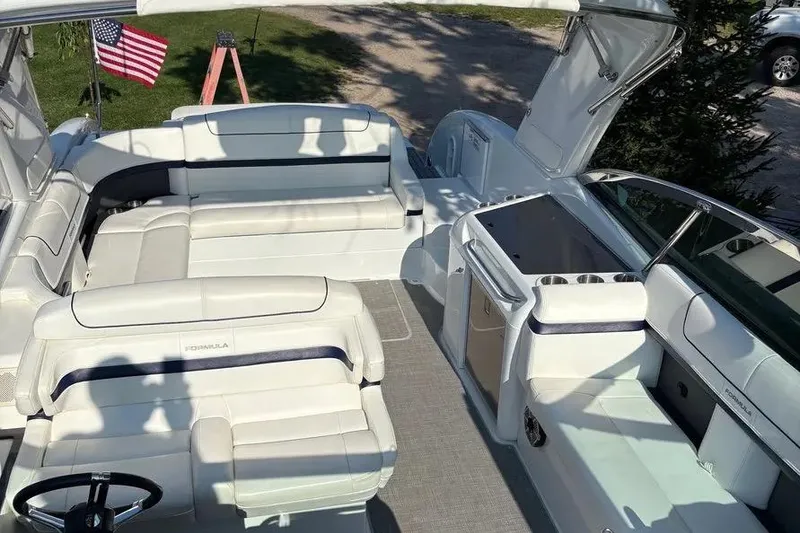 Slide: The Image of 2015 Formula 350 Crossover Bowrider interior with white seating and American flag. - 17