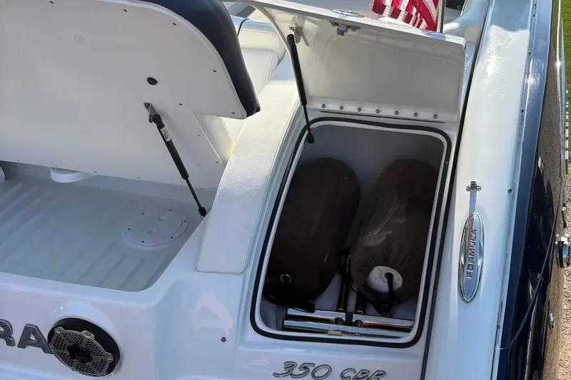 Slide: The Image of 2015 Formula 350 Crossover Bowrider storage compartment with open hatch and visible equipment. - 24