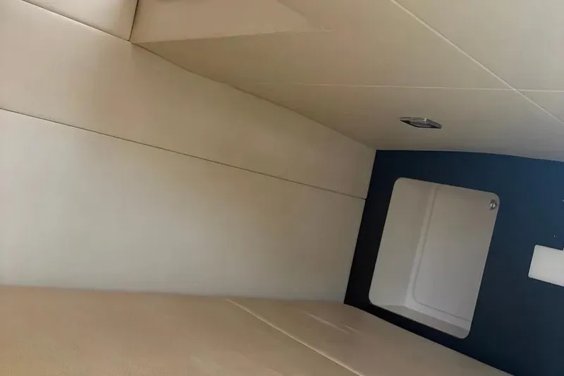 Slide: The Image of Interior cabin of 2015 Formula 350 Crossover Bowrider, featuring beige upholstery and modern design. - 27