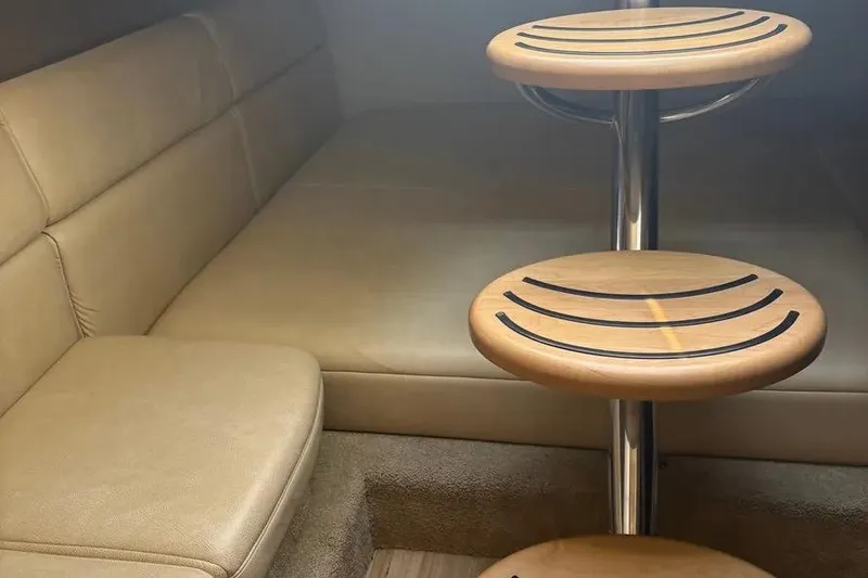 Slide: The Image of Interior of 2015 Formula 350 Crossover Bowrider with beige seating and wooden steps. - 30
