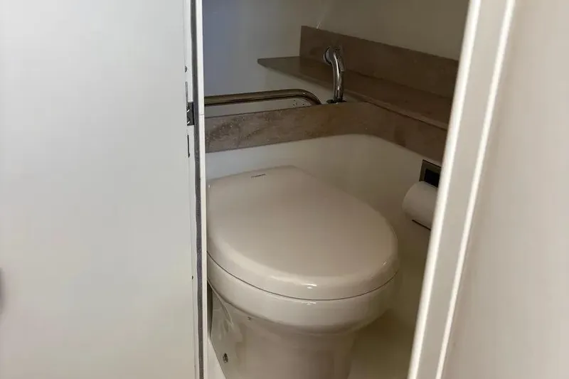 Slide: The Image of 2015 Formula 350 Crossover Bowrider bathroom with toilet and sink. - 31