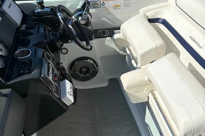 Slide: The Image of Interior of 2015 Formula 350 Crossover Bowrider, featuring steering wheel and white seating. - 37