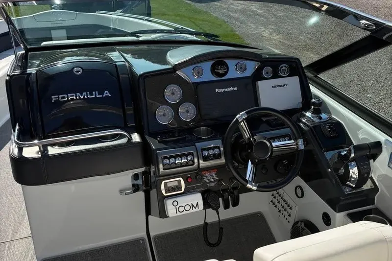 Slide: The Image of 2015 Formula 350 Crossover Bowrider dashboard with steering wheel and navigation controls. - 38