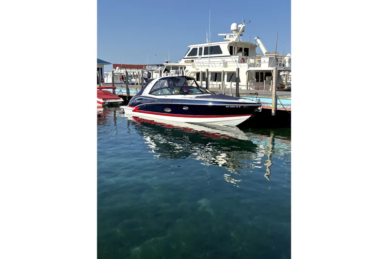 The Image of 2015 Formula 350 Crossover Bowrider docked in a marina under clear blue skies. - 9