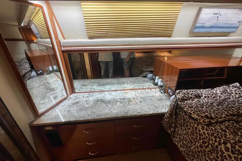 Slide: The Image of 1989 Sea Ray 380 Aft Cabin interior with granite countertop and leopard print bedding. - 11