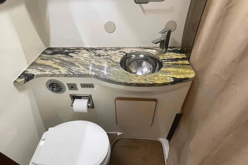 Slide: The Image of 1989 Sea Ray 380 Aft Cabin bathroom with granite countertop and modern fixtures. - 12
