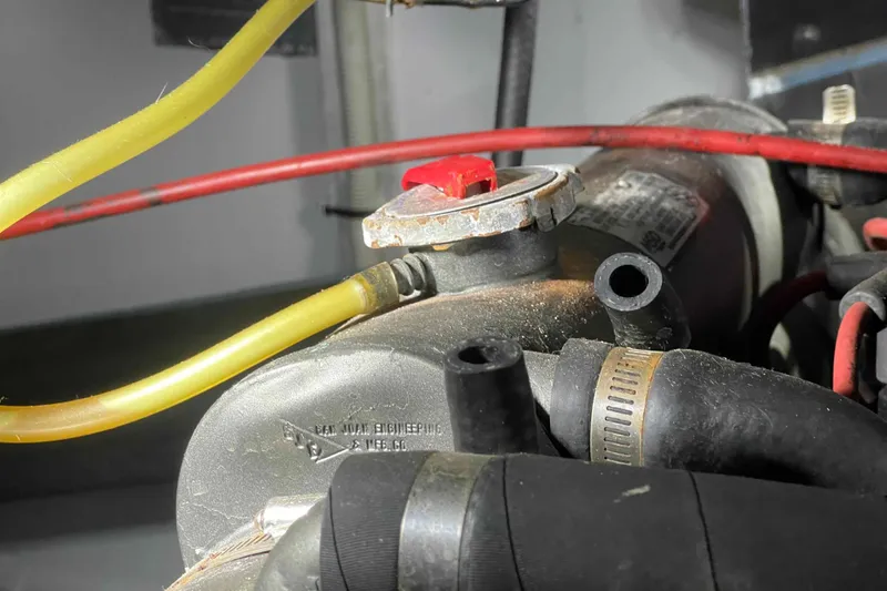 Slide: The Image of Engine components of a 1989 Sea Ray 380 Aft Cabin boat, featuring hoses and connectors. - 29