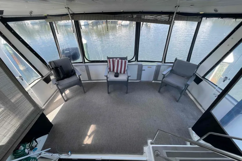 Slide: The Image of Interior of 1989 Sea Ray 380 Aft Cabin with chairs and water view. - 31