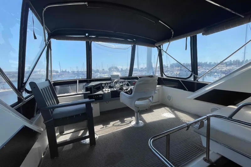 Slide: The Image of 1989 Sea Ray 380 Aft Cabin helm with panoramic marina view. - 32