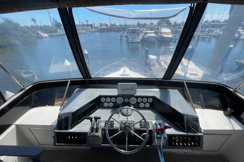 Slide: The Image of Helm of 1989 Sea Ray 380 Aft Cabin yacht with marina view. - 35
