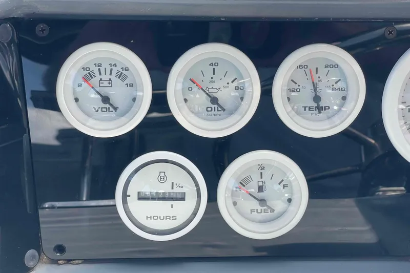 Slide: The Image of Dashboard gauges of a 1989 Sea Ray 380 Aft Cabin boat, showing voltage, oil, temperature, and fuel levels. - 37
