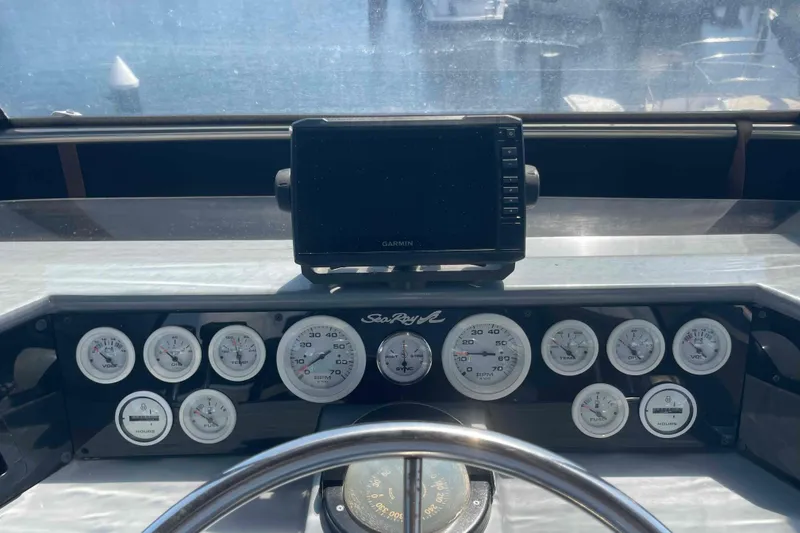 Slide: The Image of Dashboard of a 1989 Sea Ray 380 Aft Cabin with gauges and Garmin display. - 38