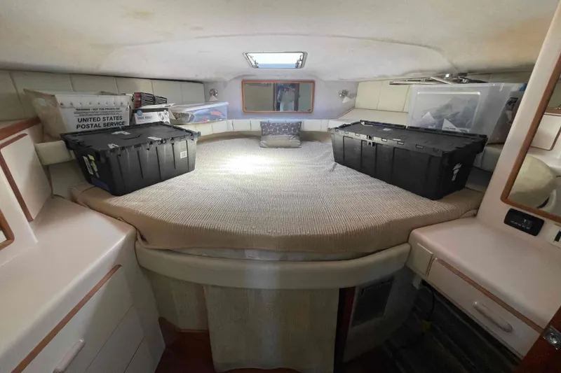Slide: The Image of 1989 Sea Ray 380 Aft Cabin interior with storage boxes on bed. - 4
