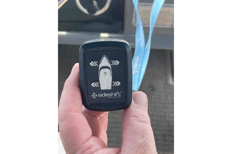 Slide: The Image of Hand holding Sideshift remote for 1989 Sea Ray 380 Aft Cabin boat. - 41