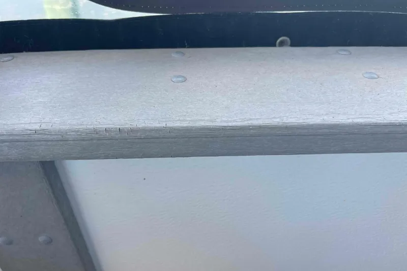 Slide: The Image of Close-up of a 1989 Sea Ray 380 Aft Cabin boat's weathered wooden surface. - 44