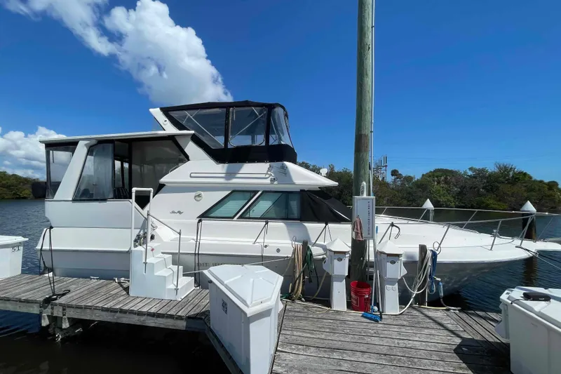 Slide: The Image of 1989 Sea Ray 380 Aft Cabin yacht docked at marina under clear blue sky. - 46