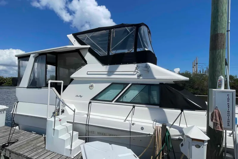 Slide: The Image of 1989 Sea Ray 380 Aft Cabin yacht docked under clear blue sky. - 47
