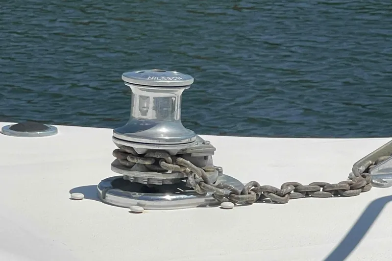 Slide: The Image of Anchor windlass on 1989 Sea Ray 380 Aft Cabin boat, with chain on deck. - 54