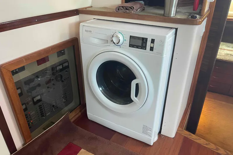 Slide: The Image of Washing machine inside 1989 Sea Ray 380 Aft Cabin yacht, next to control panel. - 6