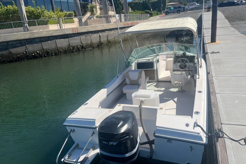 Slide: The Image of 1986 Grady-White Tournament 190 boat docked, featuring spacious seating and Yamaha outboard motor. - 10