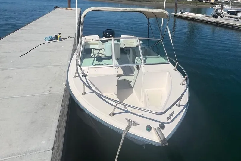 Slide: The Image of 1986 Grady-White Tournament 190 boat docked on calm water. - 4