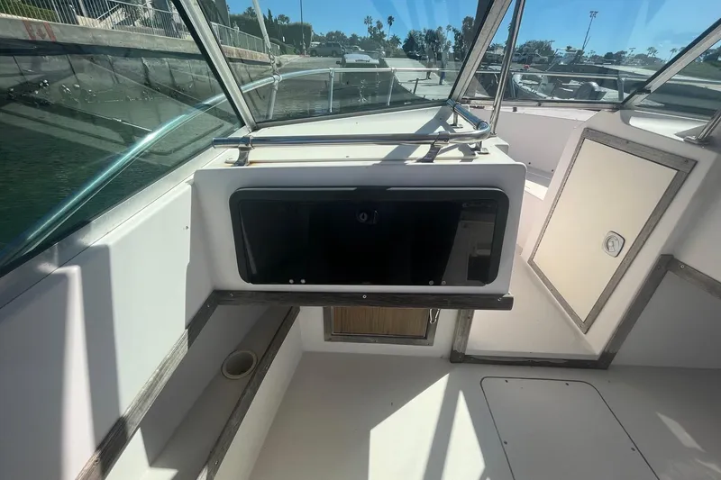 Slide: The Image of 1986 Grady-White Tournament 190 boat interior with windshield and storage compartment. - 9