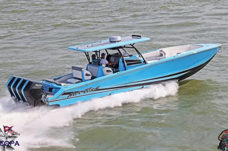 The Image of 2025 Nor-Tech 390 Sport Center Console boat cruising on water, featuring vibrant blue design. - 0