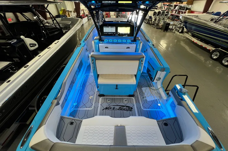 Slide: The Image of 2025 Nor-Tech 390 Sport Center Console with blue LED lighting and modern interior design. - 10