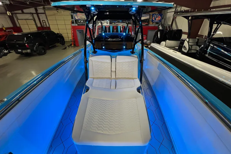 Slide: The Image of 2025 Nor-Tech 390 Sport Center Console with blue LED lighting and white seating. - 12